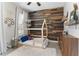 Charming bedroom features a wood accent wall, a house frame bed, and plenty of natural light at 557 Lake Cove Pointe Cir, Winter Garden, FL 34787