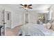 Bright bedroom features carpeted floors, two closets, and a sliding glass door to the outside at 557 Lake Cove Pointe Cir, Winter Garden, FL 34787