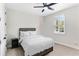Cozy bedroom with neutral colors, plantation shutters, and a comfortable bed at 557 Lake Cove Pointe Cir, Winter Garden, FL 34787