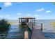 Private boat dock offering waterfront access, covered seating, and scenic views at 557 Lake Cove Pointe Cir, Winter Garden, FL 34787