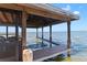 Covered boat dock with dock extensions, seating, and waterfront views at 557 Lake Cove Pointe Cir, Winter Garden, FL 34787