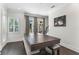 Bright dining room features hardwood floors, neutral paint, and sliding glass doors to the outside at 557 Lake Cove Pointe Cir, Winter Garden, FL 34787