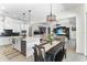 Open concept dining area featuring a table, island seating, and view into the living area at 557 Lake Cove Pointe Cir, Winter Garden, FL 34787