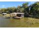 Charming screened dock featuring bench seating for relaxing by the water at 557 Lake Cove Pointe Cir, Winter Garden, FL 34787