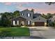 Charming two-story home with manicured lawn and beautiful stone accents, creating inviting curb appeal at 557 Lake Cove Pointe Cir, Winter Garden, FL 34787