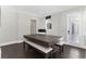 Game room features hardwood floors, neutral paint, crown molding, and sliding glass doors at 557 Lake Cove Pointe Cir, Winter Garden, FL 34787