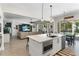 Modern kitchen featuring an island with a sink, stainless steel appliances, and pendant lighting at 557 Lake Cove Pointe Cir, Winter Garden, FL 34787