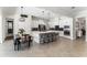 Modern, open kitchen featuring white cabinetry, stainless steel appliances, and a spacious island with bar seating at 557 Lake Cove Pointe Cir, Winter Garden, FL 34787