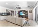 Bright living room showcasing a large sectional, an aquarium, a stairway, and an entertainment center at 557 Lake Cove Pointe Cir, Winter Garden, FL 34787