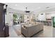 Spacious living area featuring a large sectional sofa, a ceiling fan, and views of the pool through sliding glass doors at 557 Lake Cove Pointe Cir, Winter Garden, FL 34787