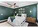 Bright bedroom with accent wall, tray ceiling and ample natural light creating a cozy retreat at 557 Lake Cove Pointe Cir, Winter Garden, FL 34787