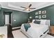 Spacious bedroom with a plush rug, accent wall, and a ceiling fan at 557 Lake Cove Pointe Cir, Winter Garden, FL 34787