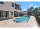 Stunning pool with a built-in lounge and views of the home's balcony and manicured yard at 557 Lake Cove Pointe Cir, Winter Garden, FL 34787