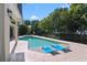 Refreshing pool with in-pool loungers, spa, and lush landscaping at 557 Lake Cove Pointe Cir, Winter Garden, FL 34787