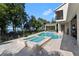 Beautiful pool and spa with a view of the surrounding greenery and blue skies at 557 Lake Cove Pointe Cir, Winter Garden, FL 34787