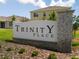 Attractive Trinity Place community sign with beautiful landscaping situated in front of picturesque homes at 6055 Vision Rd, St Cloud, FL 34771
