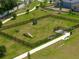 Aerial view of a fenced dog park featuring agility equipment, benches, and waste stations at 6055 Vision Rd, St Cloud, FL 34771