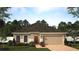 Charming single-story home featuring a two-car garage, manicured lawn, and beautifully landscaped front yard at 6055 Vision Rd, St Cloud, FL 34771