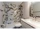 Bathroom featuring elegant marble-style tile, a modern vanity, and a sleek design at 635 San Lanta Cir, Sanford, FL 32771