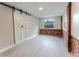 Bedroom featuring a sliding barn door closet, brick accent walls, and new vinyl flooring at 635 San Lanta Cir, Sanford, FL 32771