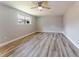Spacious bedroom featuring wood-look floors, a ceiling fan, and natural light from the window at 635 San Lanta Cir, Sanford, FL 32771
