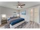 Bedroom featuring a ceiling fan, window, barn door accent and light-colored floors at 635 San Lanta Cir, Sanford, FL 32771