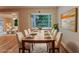 Elegant dining room with a large window, ample seating, and views of the outdoor greenery at 635 San Lanta Cir, Sanford, FL 32771