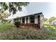Charming single-story brick home featuring shuttered windows and mature trees at 635 San Lanta Cir, Sanford, FL 32771