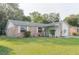 Charming single-story brick home with well-maintained lawn and mature trees, offering classic curb appeal at 635 San Lanta Cir, Sanford, FL 32771