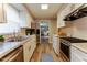 Modern kitchen featuring white cabinets, stainless steel appliances, and hardwood floors, offering style and functionality at 635 San Lanta Cir, Sanford, FL 32771