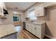 Kitchen with white cabinets, stainless steel appliances, stone countertops and wood-look flooring and view to dining area at 635 San Lanta Cir, Sanford, FL 32771