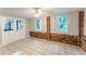 Open and spacious living area featuring tile flooring, brick accent walls, and a glass door to the exterior at 635 San Lanta Cir, Sanford, FL 32771
