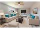 Bright staged living room with hardwood flooring, ceiling fan, large window, and comfortable seating arrangement at 635 San Lanta Cir, Sanford, FL 32771