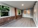 Bright living room with modern flooring, exposed brick and windows with outdoor views at 635 San Lanta Cir, Sanford, FL 32771
