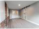 Bright living room with modern flooring, barn door accent and glass French doors at 635 San Lanta Cir, Sanford, FL 32771