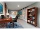 Bright, staged office with hardwood floors, desk, book shelf, and brick accent wall at 635 San Lanta Cir, Sanford, FL 32771
