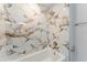 Close up of newly remodeled shower with marble-style tile and updated fixtures at 635 San Lanta Cir, Sanford, FL 32771