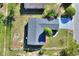 An aerial view of a light blue house with a fenced backyard in a neighborhood setting at 642 Carver Dr, Lake Wales, FL 33853