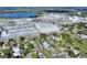 Aerial view of neighborhood homes near a large industrial complex and tranquil lake at 642 Carver Dr, Lake Wales, FL 33853
