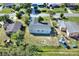 An aerial view of a light blue house with a fenced backyard in a neighborhood setting at 642 Carver Dr, Lake Wales, FL 33853