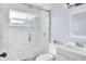 Updated bathroom with marble shower, modern vanity, and neutral colors at 642 Carver Dr, Lake Wales, FL 33853