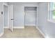 Cozy bedroom with tile flooring, closet and natural light from window at 642 Carver Dr, Lake Wales, FL 33853
