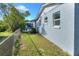 Side exterior view of a light blue home featuring newer windows and well kept lawn at 642 Carver Dr, Lake Wales, FL 33853