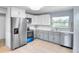 Modern kitchen with stainless steel appliances, white cabinetry, and stone countertops at 642 Carver Dr, Lake Wales, FL 33853