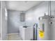 Functional laundry room includes washer, water heater, and utility sink at 642 Carver Dr, Lake Wales, FL 33853