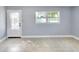 A spacious living room with tiled floors and a glass-accented entry door and natural light at 642 Carver Dr, Lake Wales, FL 33853