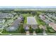 Aerial view of a residential property with a pond in the backyard, showcasing the surrounding neighborhood at 646 Marsh Reed Dr, Winter Garden, FL 34787