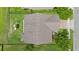 A bird's eye view showcases a well-maintained roof, a fenced yard, and a playset at 646 Marsh Reed Dr, Winter Garden, FL 34787