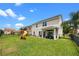 Spacious fenced backyard with a playground, patio seating, and a lush green lawn at 646 Marsh Reed Dr, Winter Garden, FL 34787