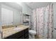 Bathroom featuring a granite countertop vanity, mirror, and a floral shower curtain at 646 Marsh Reed Dr, Winter Garden, FL 34787